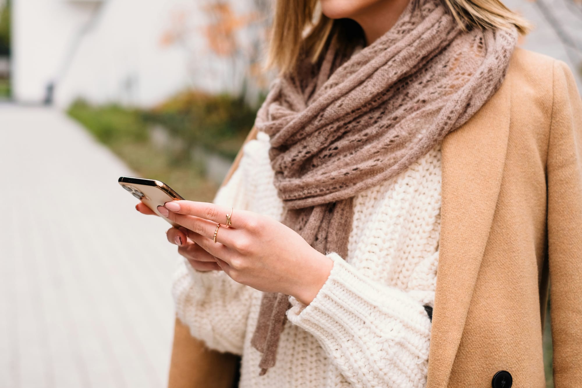 Cream knit jumper, layered with tan jacket and taupe scart